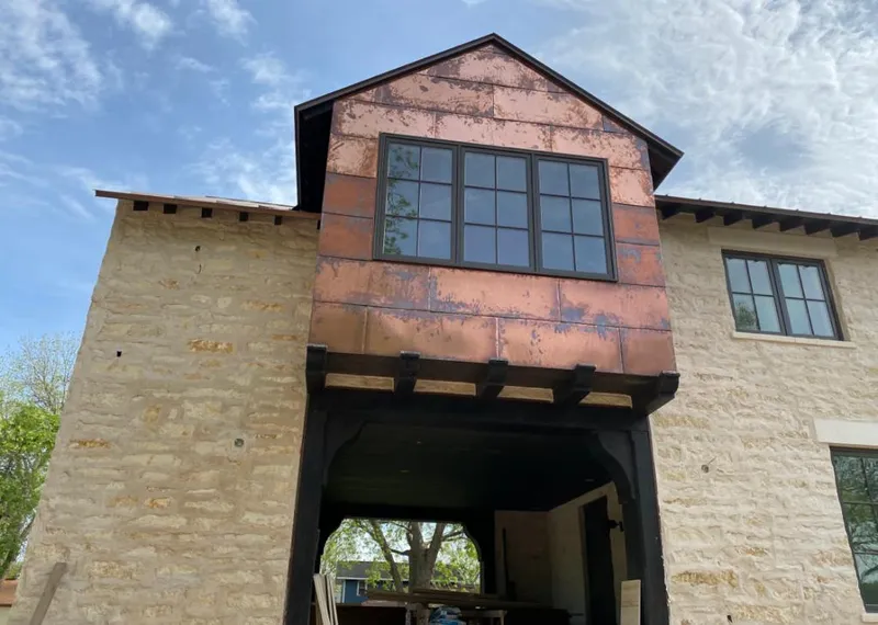 Copper metal panel facade on a stone building for Skylight Installation in Concord